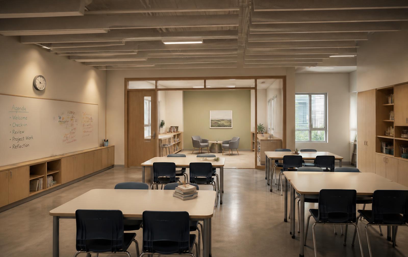 Middle school classroom with dimmable warm lighting, matte cream surfaces, ceiling acoustic baffles and a visible quiet nook beyond a glazed partition.